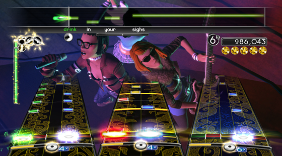 Each instrument is represented by a different interface: lead guitar (left), drums (middle), bass guitar (right), vocals (top). The Band Meter (green meter on left) measures the performance of each band member, while the Energy Meter (gold meter beneath each interface) tracks each player's Overdrive. This screenshot shows a full band playing De-Luxe - Lush.